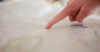 A hand pointing at a city map, highlighting direction and navigation planning.
