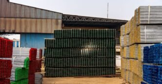 Colorful stacks of industrial materials organized in an outdoor yard, showcasing vibrant organization.